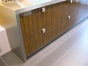 Stainless steel panels surround base units of high-gloss laminate.